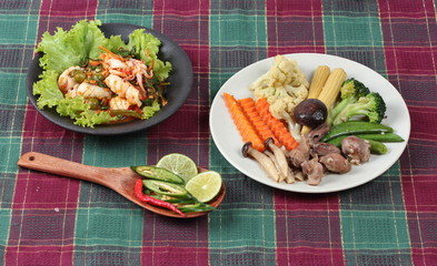 Fried chicken mixed vegetables served with fried spicy squid  mixed herb. 