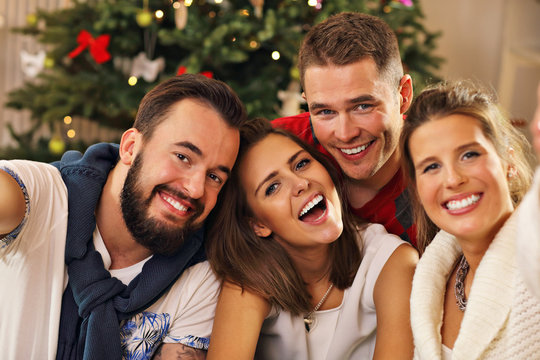 Group Of Friends Taking Selfie During Christmas