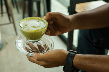 Milk green tea cup On Holding