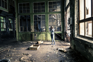 Young girl in old, ruined factory