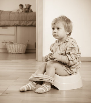 Toddler sitting on  potty