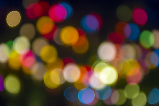 Colorful holiday Christmas lights background in bokeh bubbles 