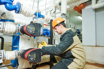 Plumber technician works with water pump