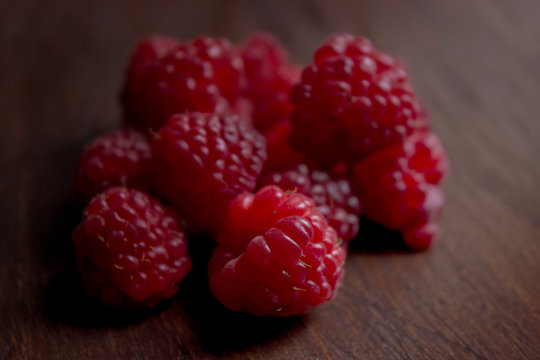Raspberries on Wooden Table Close Up