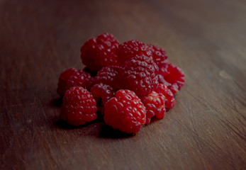 Raspberries on Wooden Table Close Up