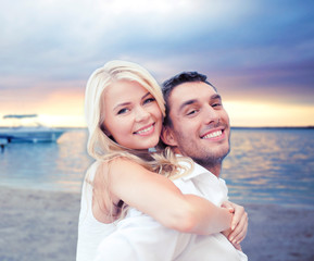 couple having fun and hugging on beach