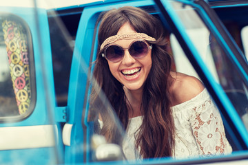 smiling young hippie woman in minivan car