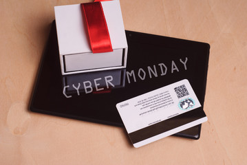 Credit card and electronic tablet on wooden table,