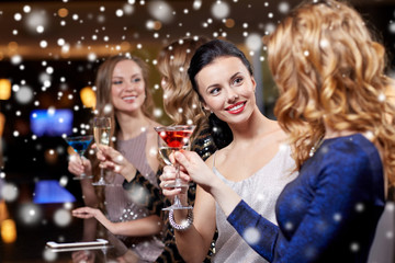 happy women with drinks at night club