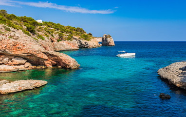 Fototapeta na wymiar Idyllic mediterranean sea bay with boat at the coastline of Majora Spain