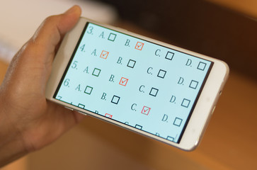 student testing quiz in exercise, exams answer on smart phone or