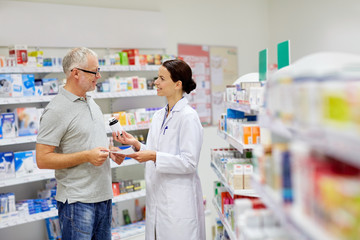 pharmacist and senior man buying drug at pharmacy - obrazy, fototapety, plakaty