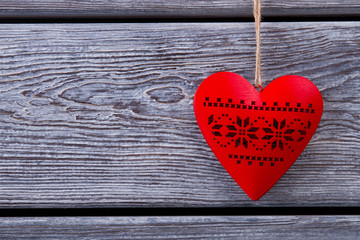 Red heart on a wooden fence with space for text.