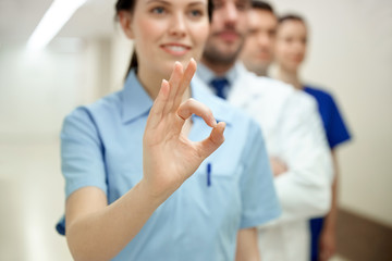 Obraz premium close up of doctors at hospital showing ok sign