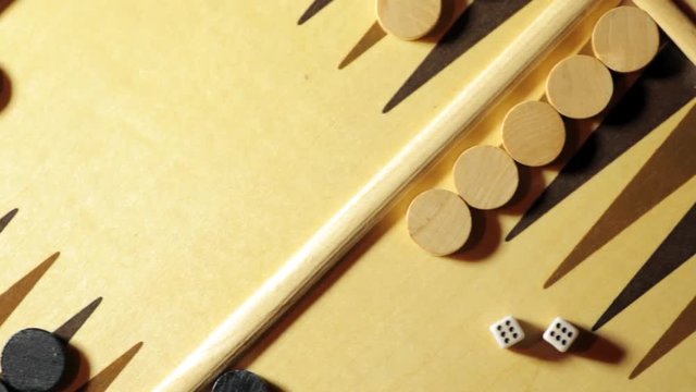 Panning shot of a backgammon board with dice.