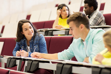 group of students with notebooks in lecture hall