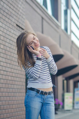 Fototapeta premium Young woman using her phone