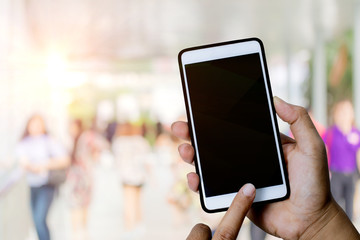 Close up of hands using smartphone on blurred background