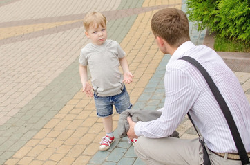 Small baby boy if having fun with is father