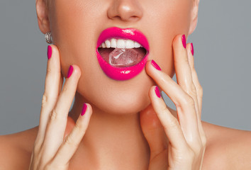Close-up shot of woman's lips with ice cube

