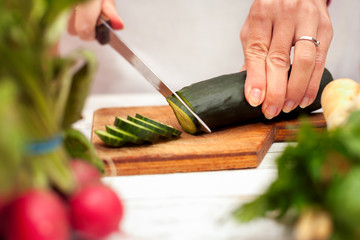 Slicing of cucumber with a knife