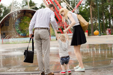 Young family is walking in the park