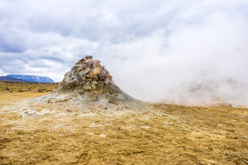 Fumarole evacuating pressurized hot sulfurous gases from volcanic activity in the geothermal area of Hverir Iceland near Lake Myvatn