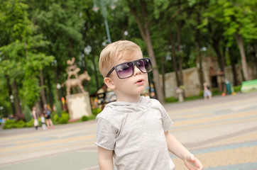 Small baby boy is faving fun in the park