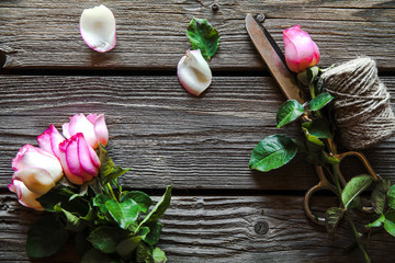 Beautiful roses on old wooden background, rewind the old thread. Flowers, gift, Valentines Day background, wedding day