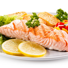 Grilled salmon and vegetables on white background