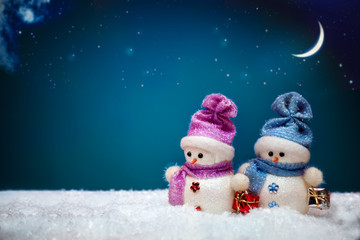 Couple of snowmen on blue winter background
