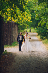 Groom and Bride in a park. wedding dress. Bridal wedding bouquet of flowers. Newlyweds on nature.