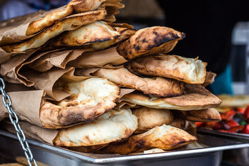 Lavash, Bakery Products fresh pastry sells pita market wheat tortillas close-up Caucasian kitchen Lavash Pita or Arabic bread traditional healthy eastern Georgian flatbreads paper bags country Georgia