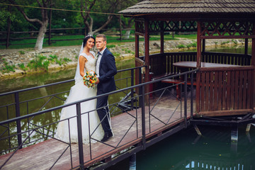 Wedding couple, bride, groom posing embacing on pier