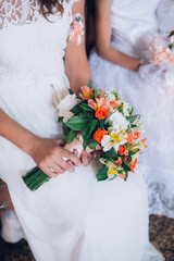 Obraz na płótnie Canvas close-up of colorful wedding bouquet at bride's hands