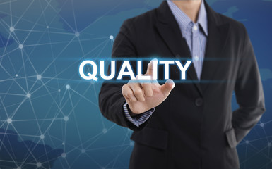 Businessman hand select wording quality. sign on virtual screen. business concept.