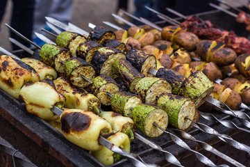 Skewered vegetables green zucchini courgettes cucumber peppers preparing barbecue grill charcoal Grilled roasted fried slices covered beautiful crust Mediterranean cuisine delicious food bbq party