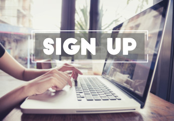 business hand typing on a laptop keyboard with Sign Up homepage on the computer screen register join applicant enroll enter membership concept.