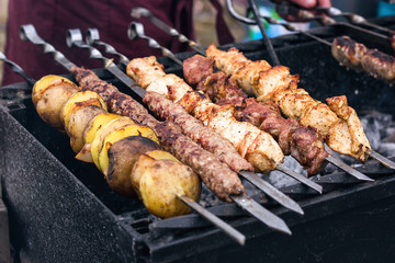 Marinated shashlik preparing on a barbecue grill over charcoal. Shashlik or Shish kebab popular in Eastern Europe. Shashlyk (skewered meat) was originally made of lamb. Roast Beef Kebabs On BBQ Grill.