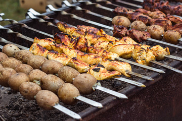 Marinated shashlik preparing on a barbecue grill over charcoal. Shashlik or Shish kebab popular in Eastern Europe. Shashlyk (skewered meat) was originally made of lamb. Roast Beef Kebabs On BBQ Grill.