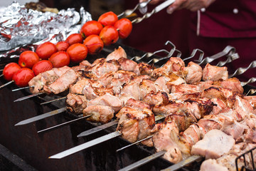 Marinated shashlik preparing on a barbecue grill over charcoal. Shashlik or Shish kebab popular in Eastern Europe. Shashlyk (skewered meat) was originally made of lamb. Roast Beef Kebabs On BBQ Grill.