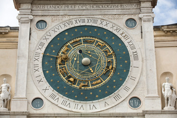 Fototapeta na wymiar Clock tower building of medieval origins overlooking Piazza dei Signori in Padova, Italy