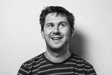 Close up of a funny young man. The collage of young man with different emotion. emotional card. Black-and-white photo.