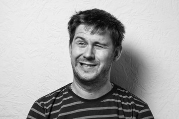 Close up of a funny young man. The collage of young man with different emotion. emotional card. Black-and-white photo.