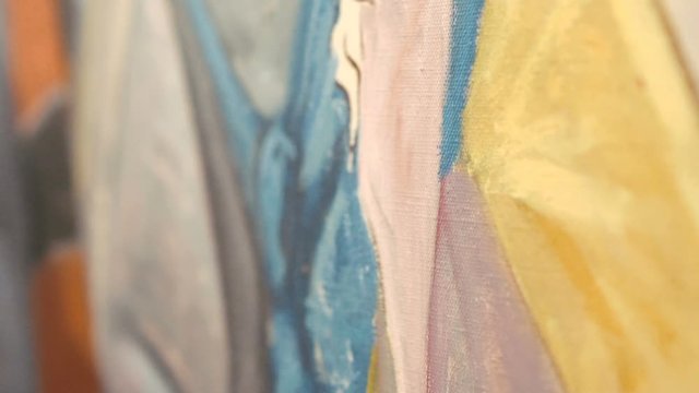 Close up of artist draws picture with paintbrush