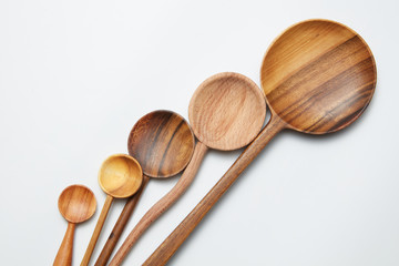 different kitchen wooden utensils on a white background