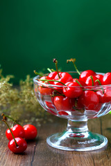 red cherries in a glass fruit dish