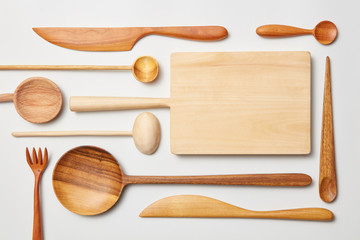 Various kitchen utensil on white wooden background