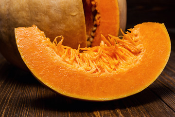cut the pumpkin, slice of pumpkin, yellow pumpkin on wooden background,  autumn pumpkin harvest,orange and yellow pumpkins on wooden background