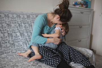 Pregnant mom and son Toddler playing with  phone, lifestyle. Rea